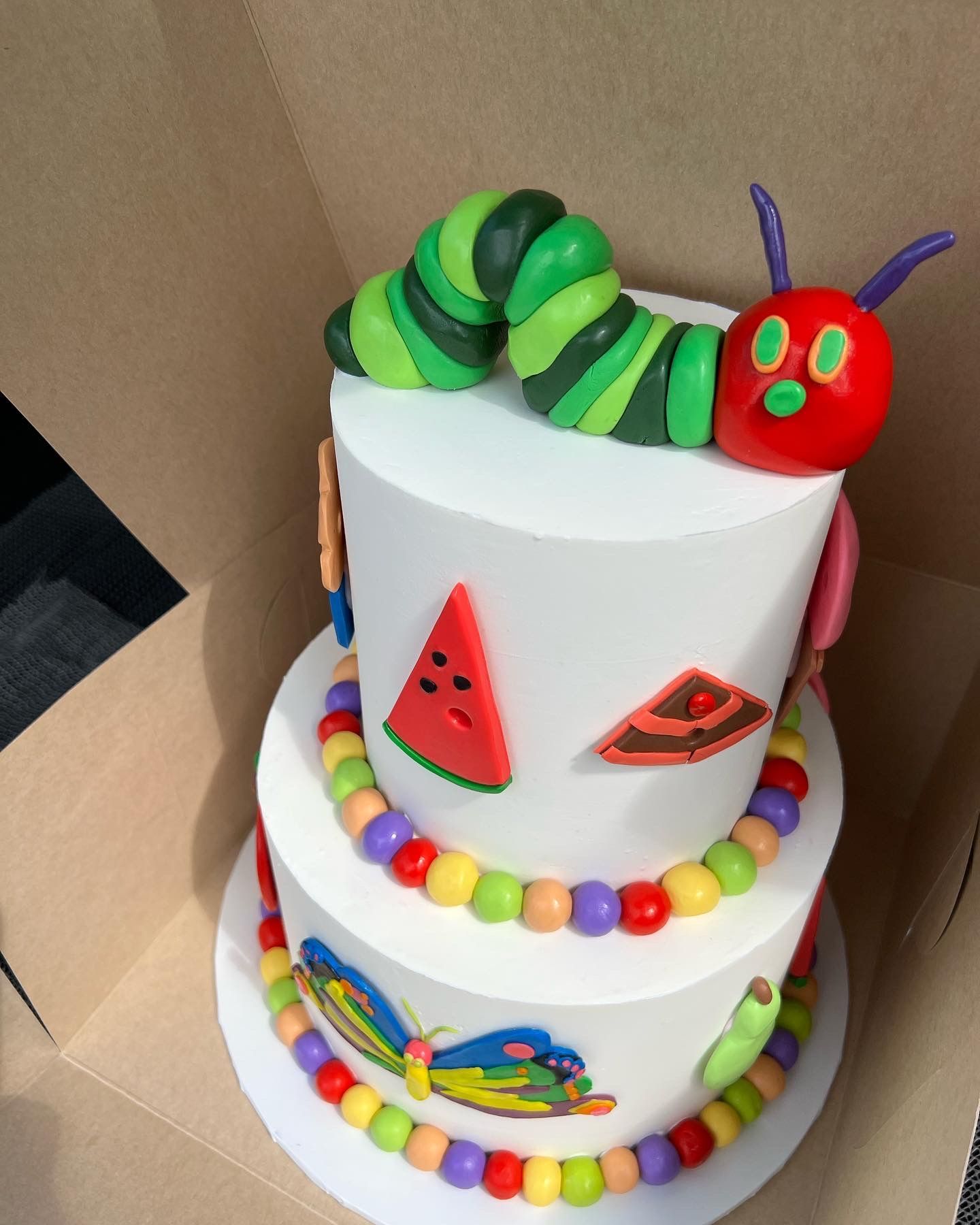a cake with a caterpillar on top of it