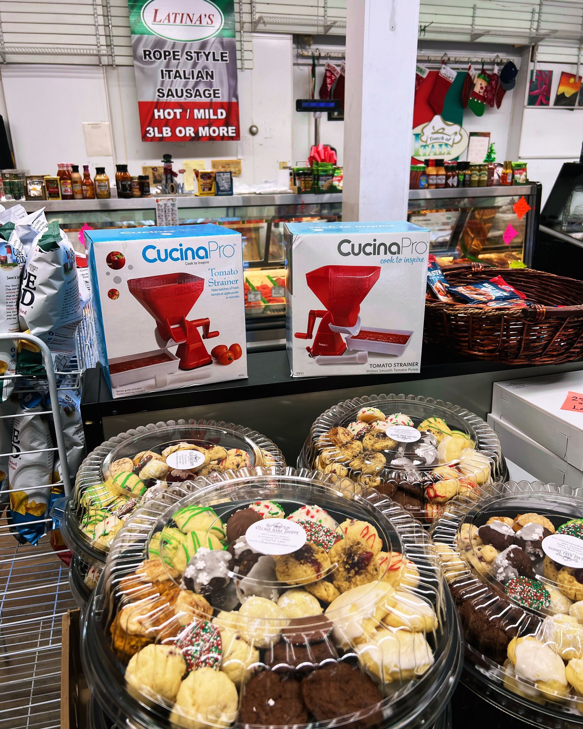 a variety of cookies are sitting on a counter in a store .