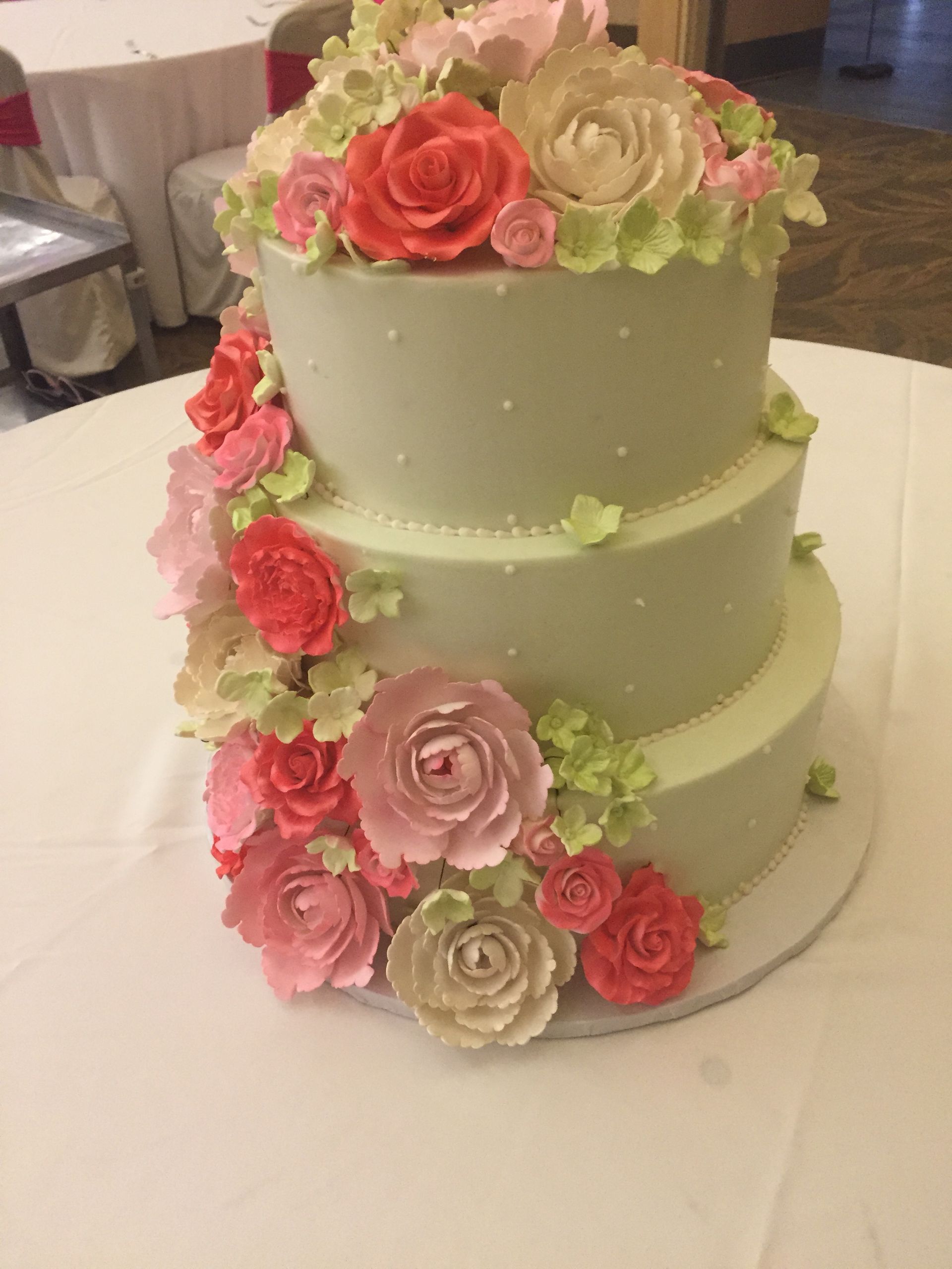 a wedding cake with pink and white roses on it