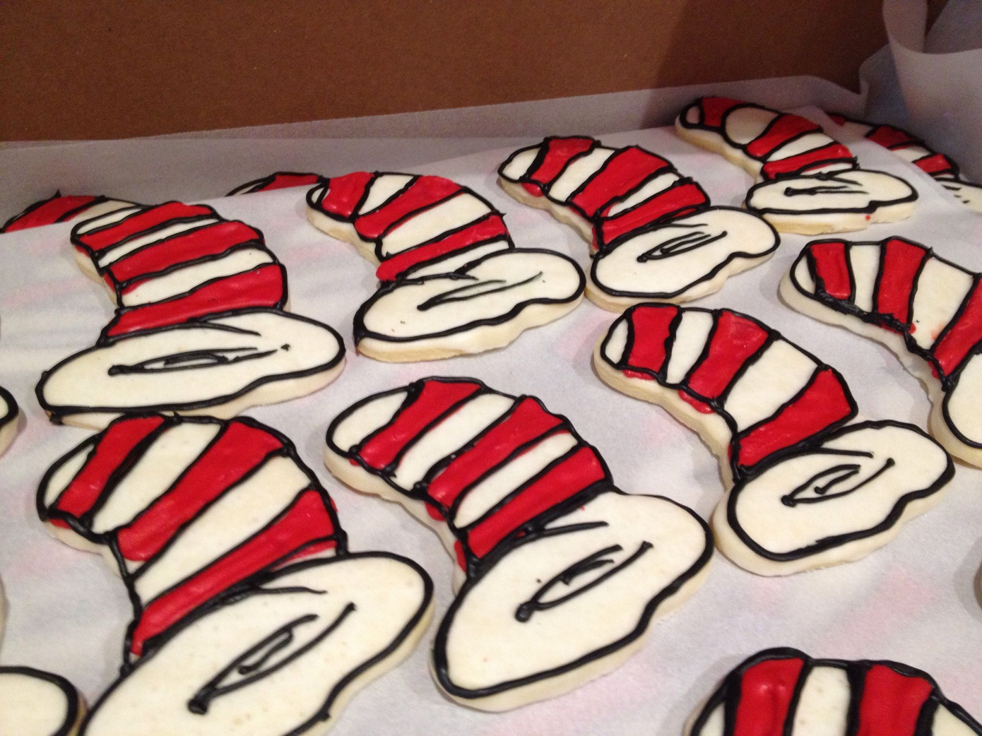 a bunch of cat in the hat cookies on a table