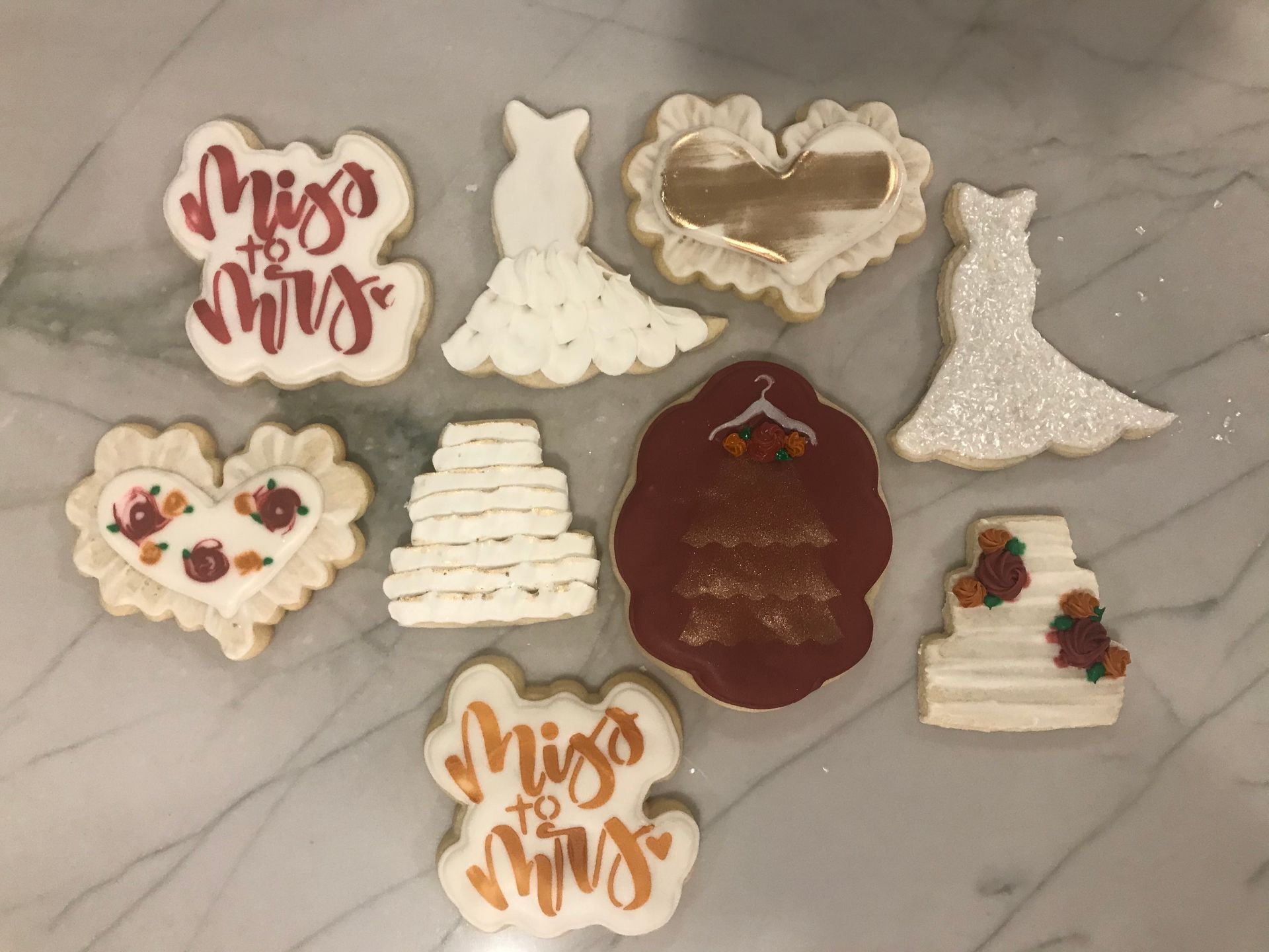 a bunch of wedding cookies are sitting on a table .
