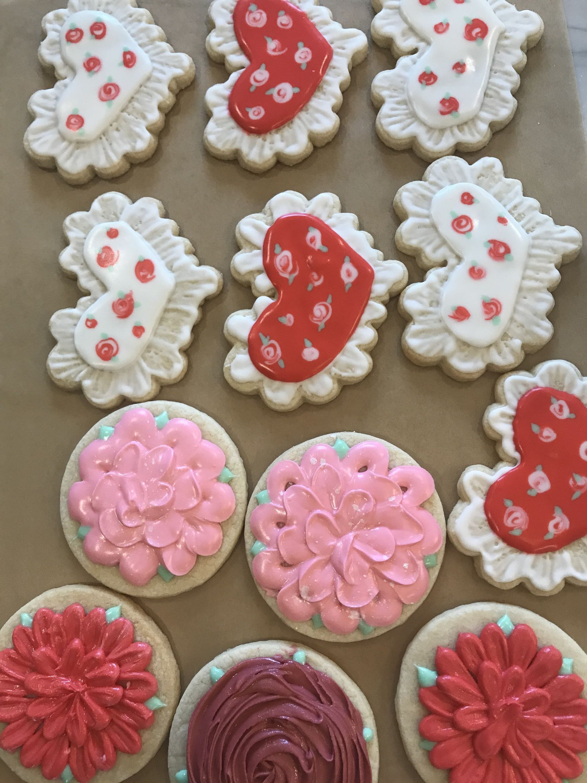 a bunch of cookies with hearts and flowers on them