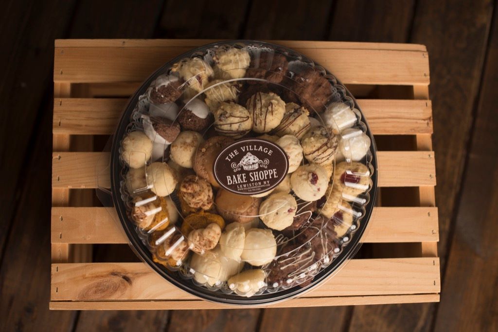 a tray of cookies is sitting on a wooden table .