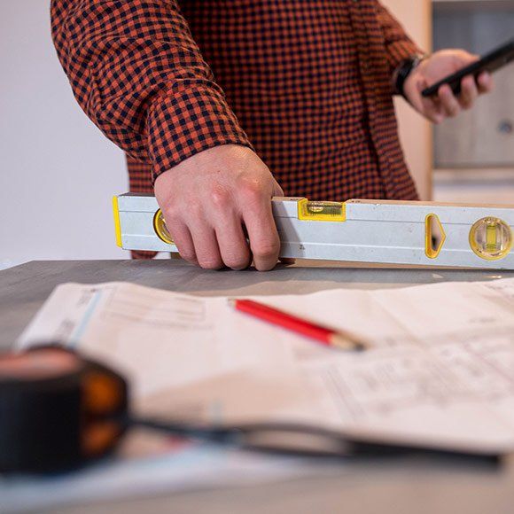 Carpenter Holding Leveling Ruler — Holbrook, MA — F.L. Smith Inc.