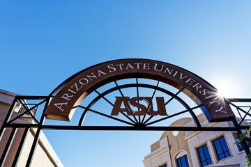 Arizona State University archway with ASU logo against a blue sky