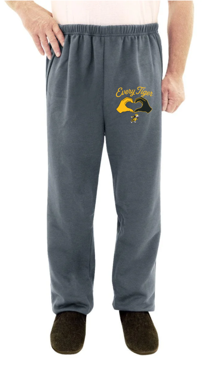 Gray sweatpants with a yellow “Cadillac” logo, shown on a person standing indoors.