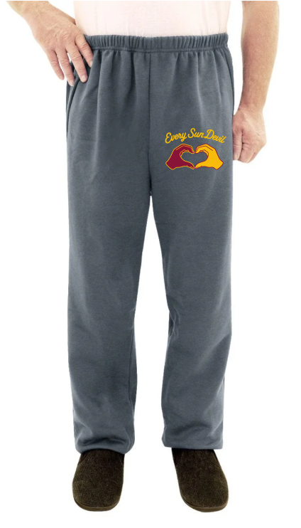 Gray sweatpants with a yellow-red graphic on the left thigh, worn by a person standing against a white background