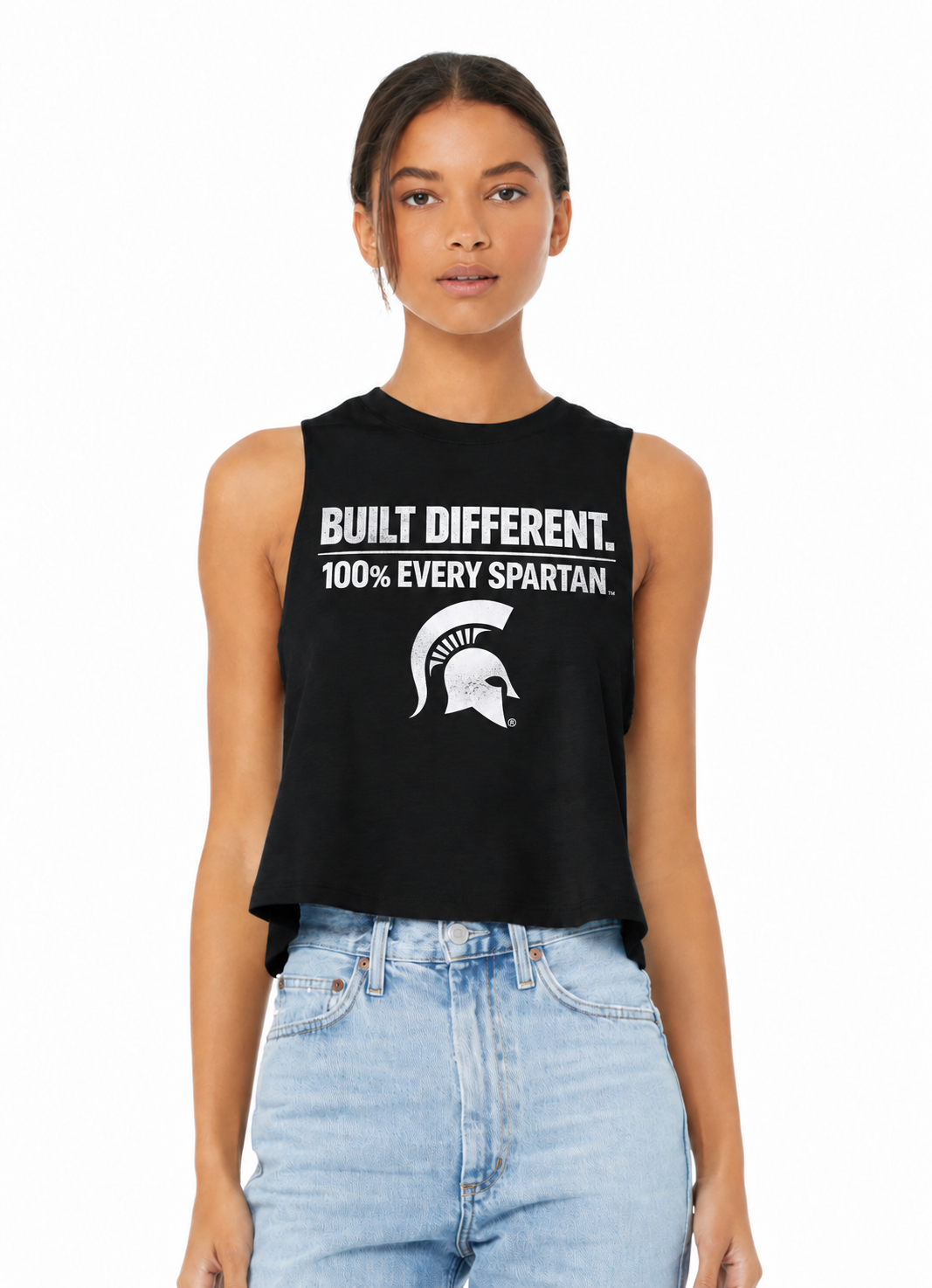 Model wearing a black sleeveless crop top with white text and a graphic, paired with light blue jeans.