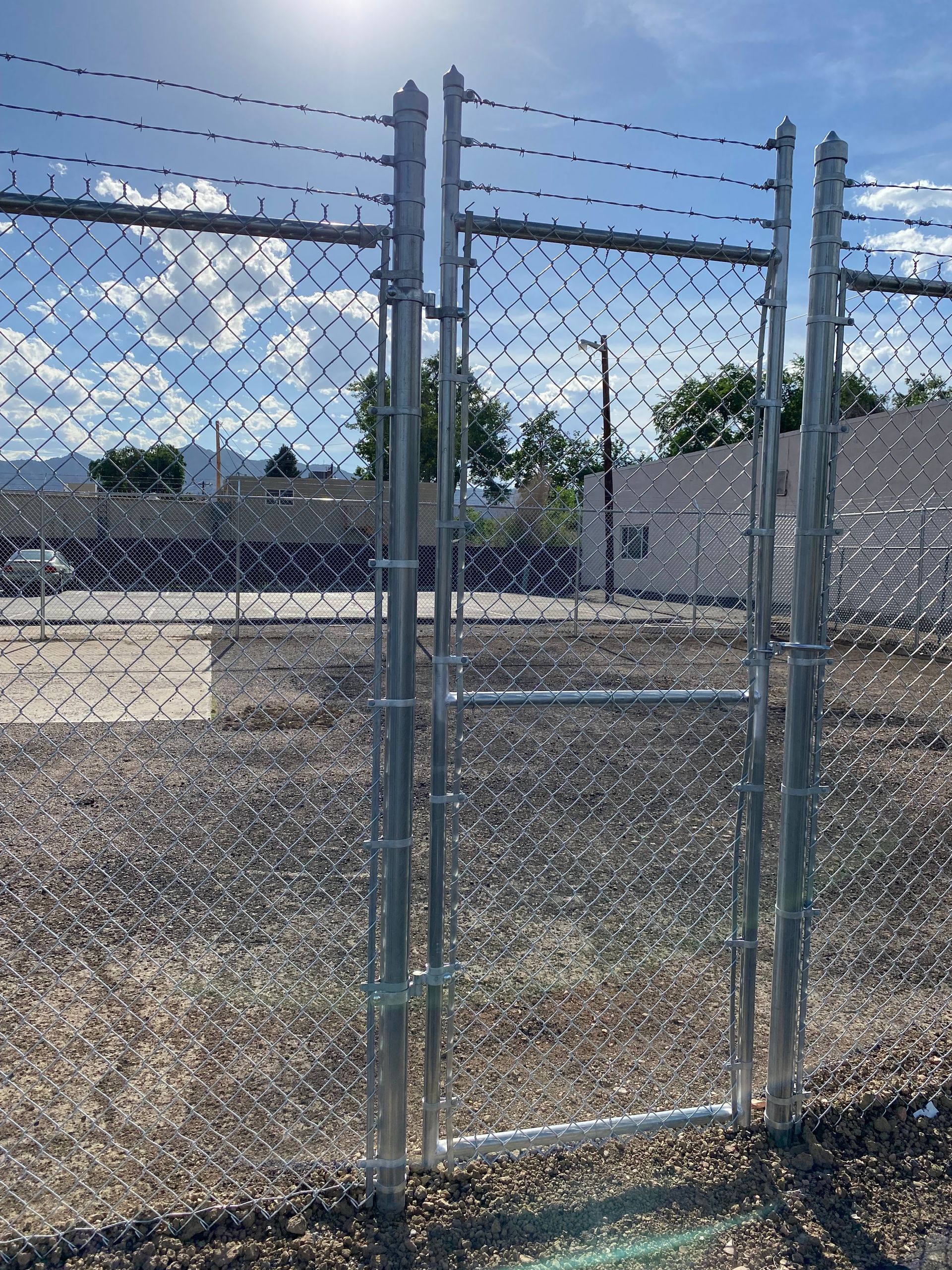 A chain link fence with a gate in the middle of it