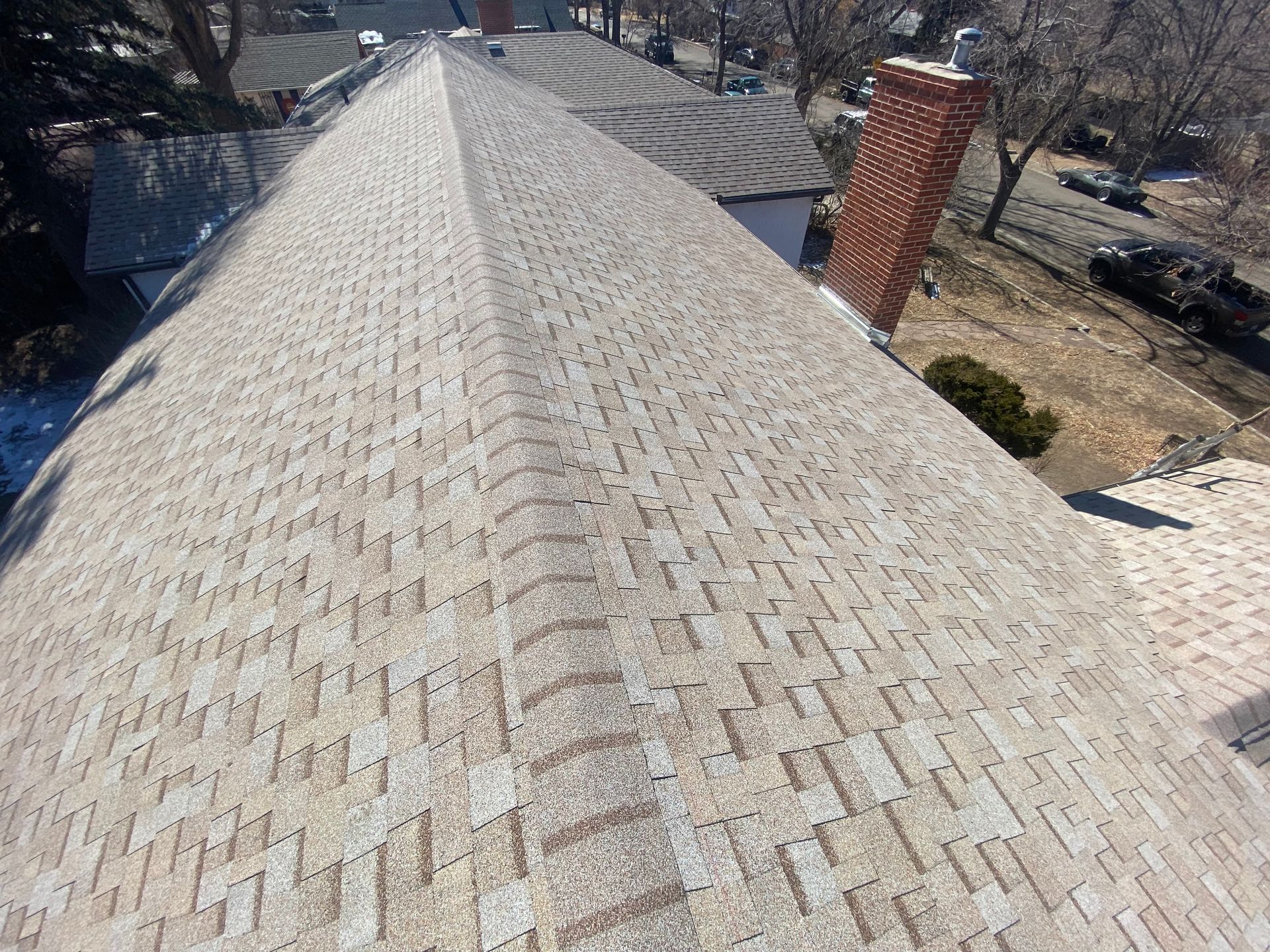 A roof with a lot of shingles and a chimney on it