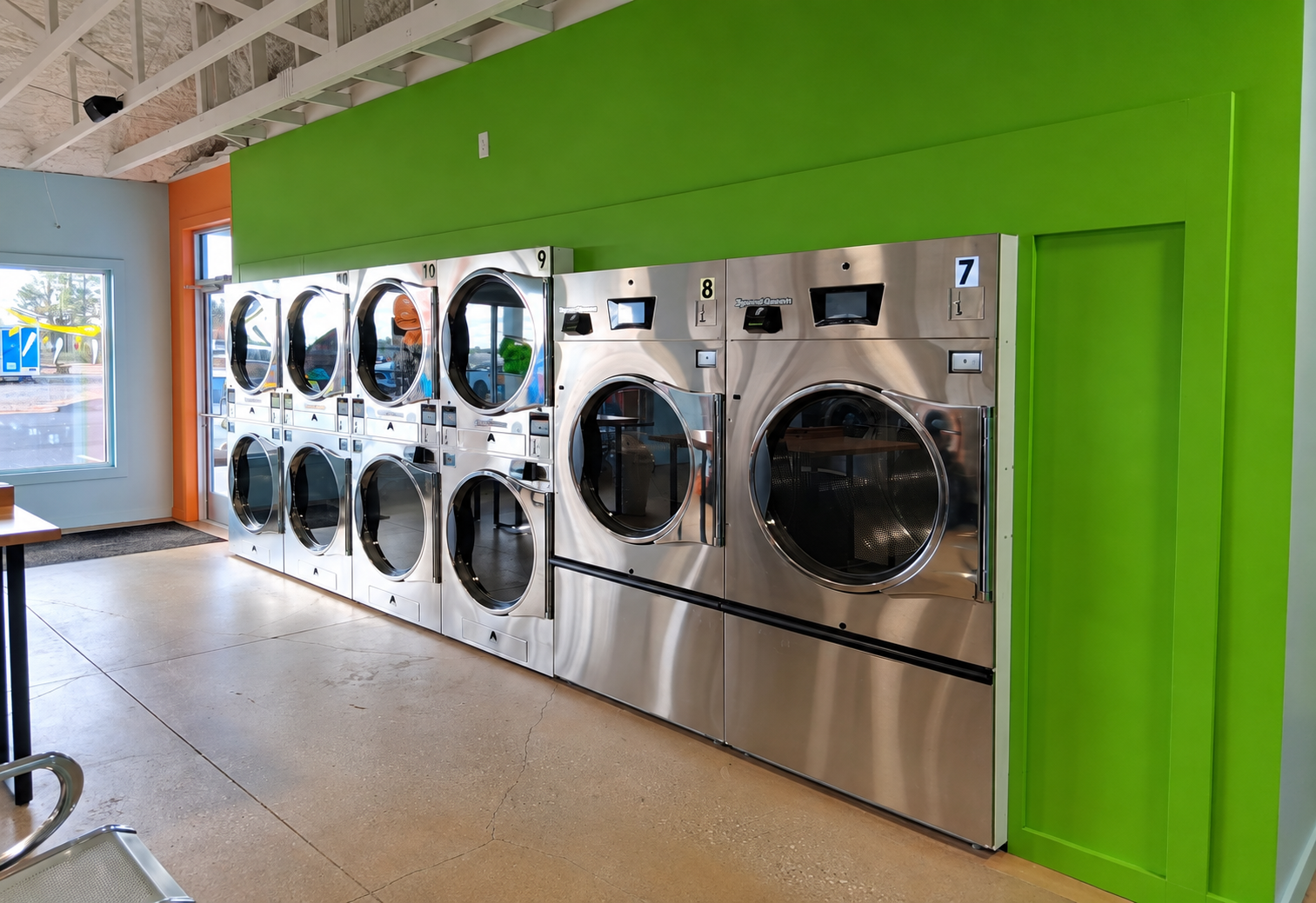 Rows of commercial dryers and washers at Sunny Day Laundromat