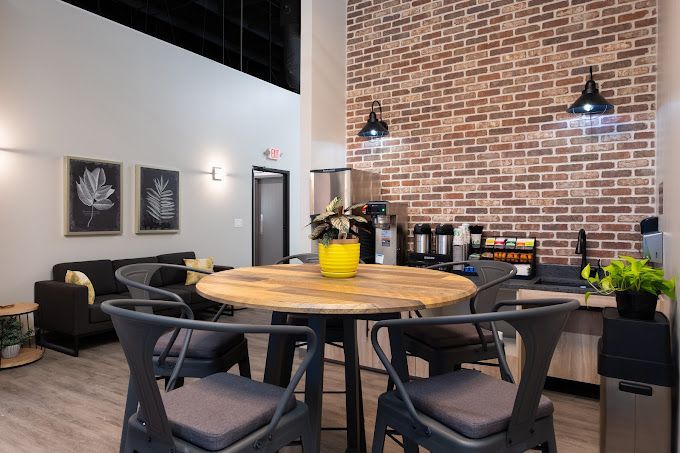 There is a table and chairs in the middle of the room.