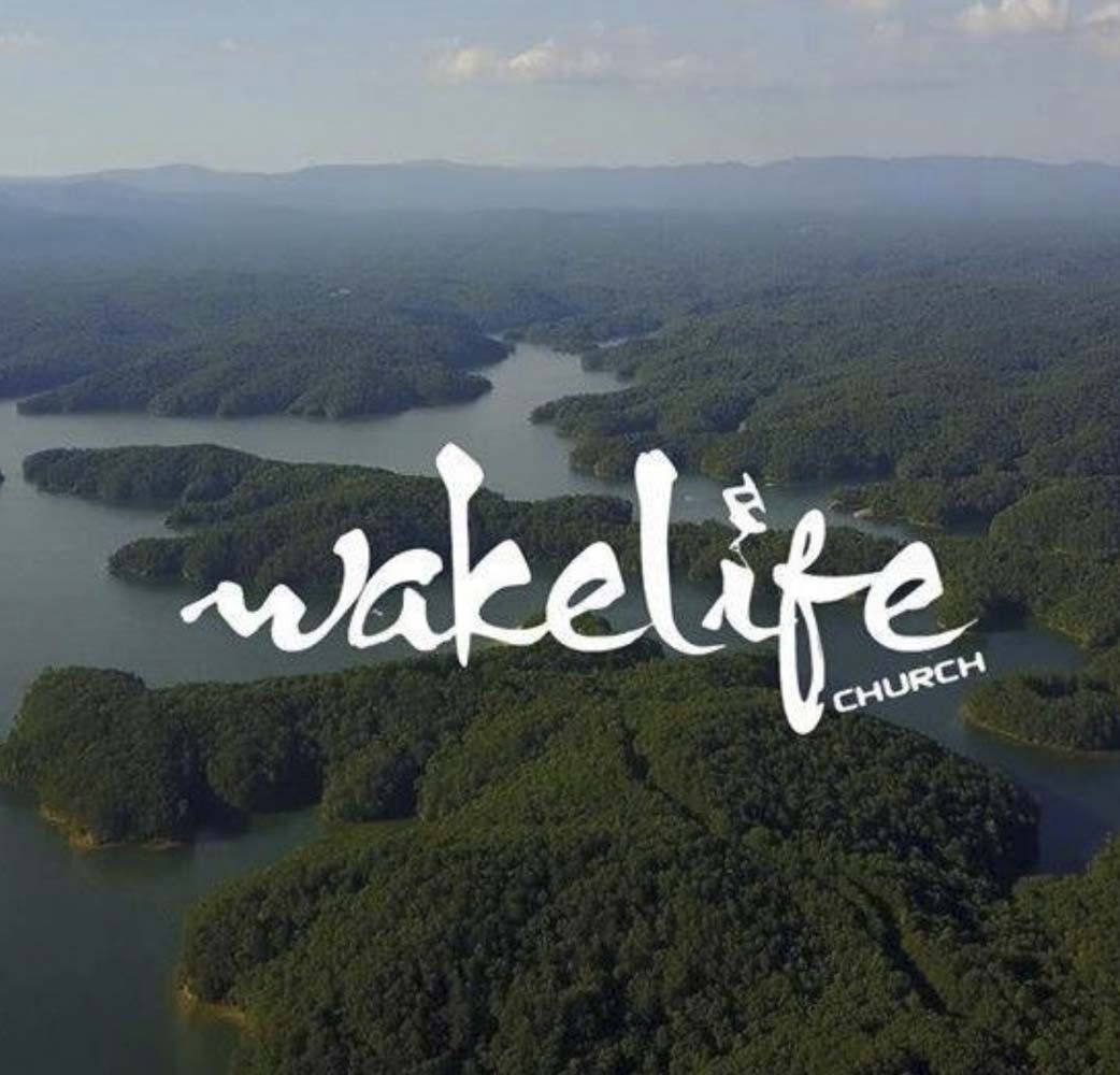 An aerial view of wakelife church with a lake in the background