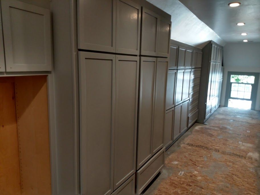 A hallway with a lot of cabinets and drawers