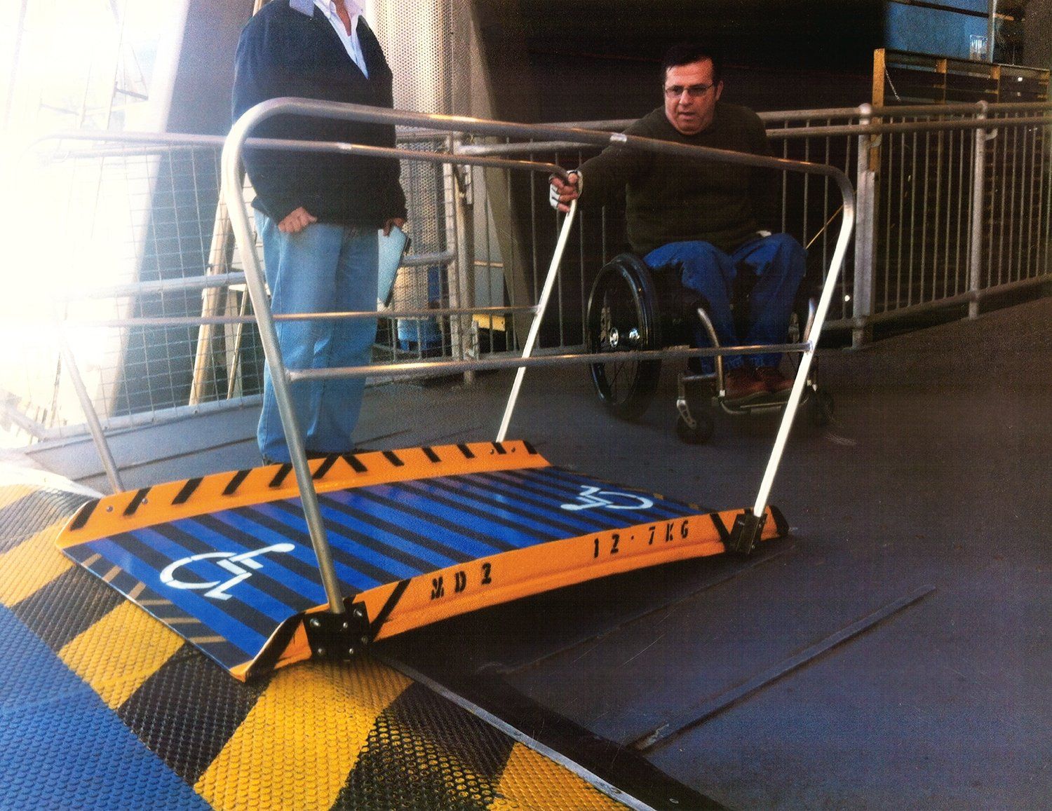 A man in a wheelchair is using a gangway
