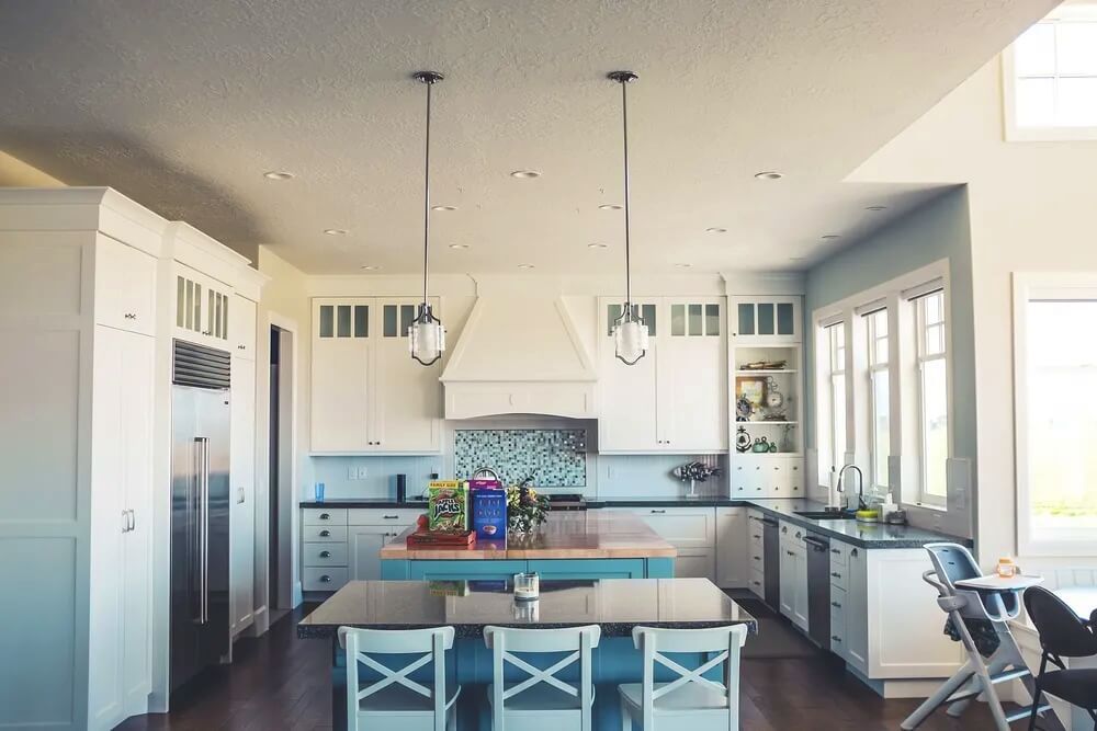 Mosaic tiles help introduce deeper shades into a coastal kitchen