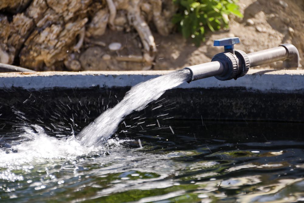 A Pipe Is Pouring Water Into A Pond — Blackpoly Pipelines in West Wyalong, NSW