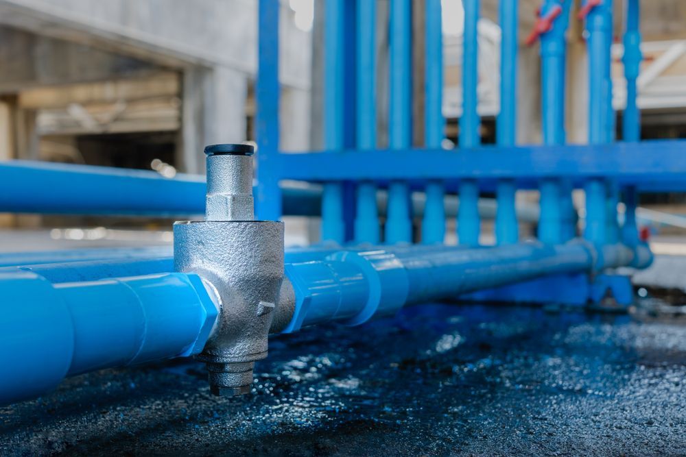 A Close Up Of A Blue Pipe With Water Coming Out Of It — Blackpoly Pipelines in Orange, NSW