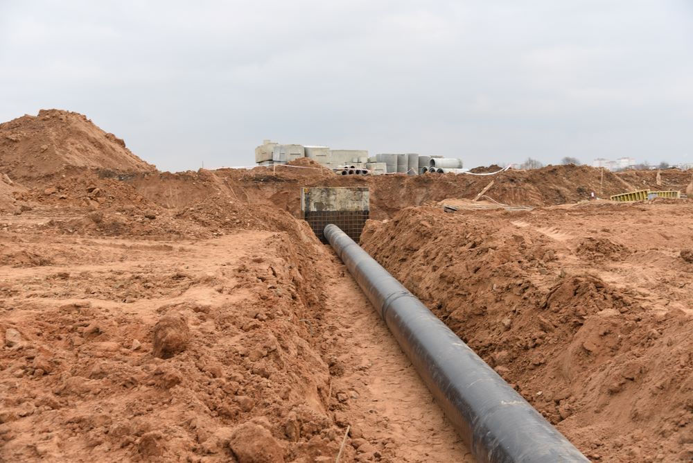 A Sizable Pipe Is Being Placed In A Dirt Trench — Blackpoly Pipelines in Gilgandra, NSW