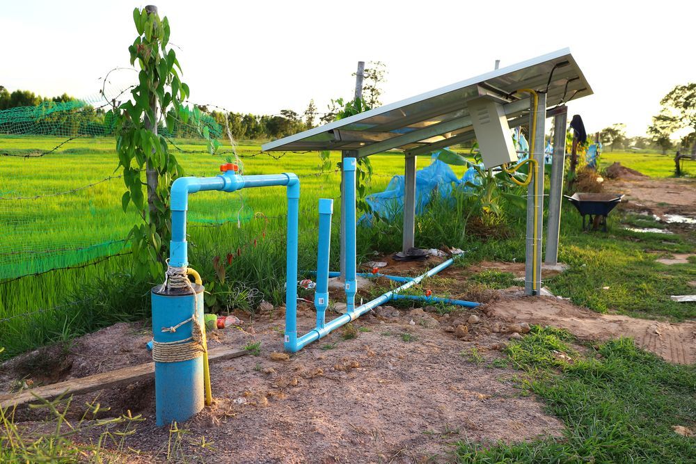 A Water Pump Is Connected To A Solar Panel In A Field — Blackpoly Pipelines in Parkes, NSW