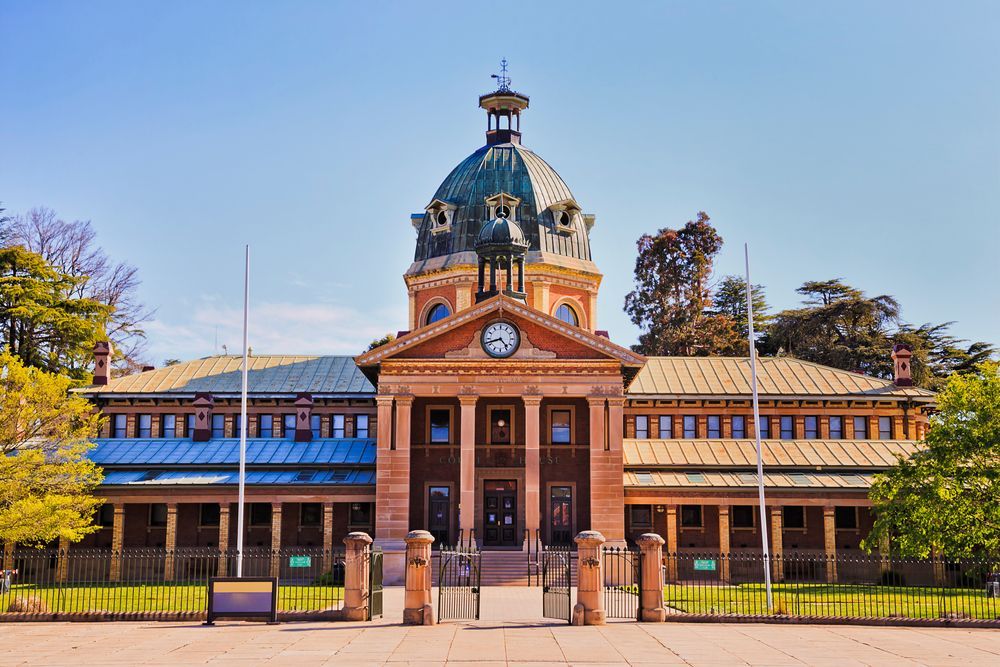 A Large Building With A Dome And A Clock On Top Of It — Blackpoly Pipelines in Bathurst, NSW