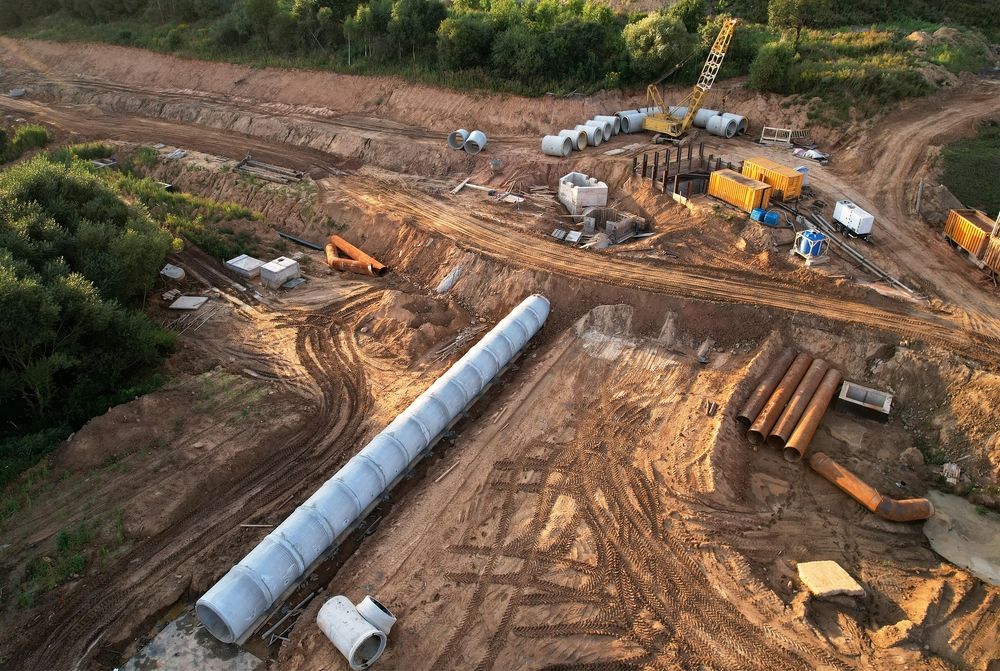 An Aerial View Of A Construction Site With Pipes And Trucks — Blackpoly Pipelines in Lithgow, NSW