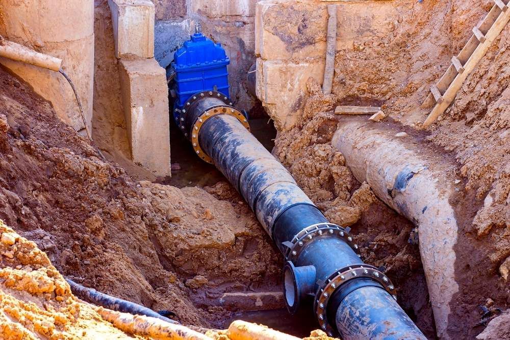 A Water Pipe Is Being Installed In A Hole In The Ground — Blackpoly Pipelines in Mount Isa, QLD