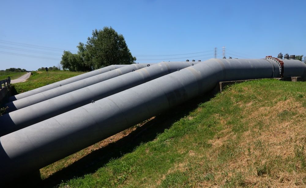 A Row Of Pipes Are Sitting On Top Of A Grassy Hill — Blackpoly Pipelines in Gilgandra, NSW