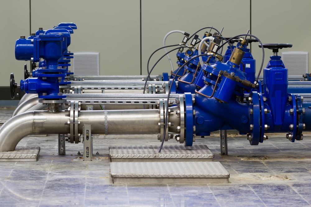 A Bunch Of Blue Pipes Are Lined Up On A Tiled Floor — Blackpoly Pipelines in Mount Isa, QLD