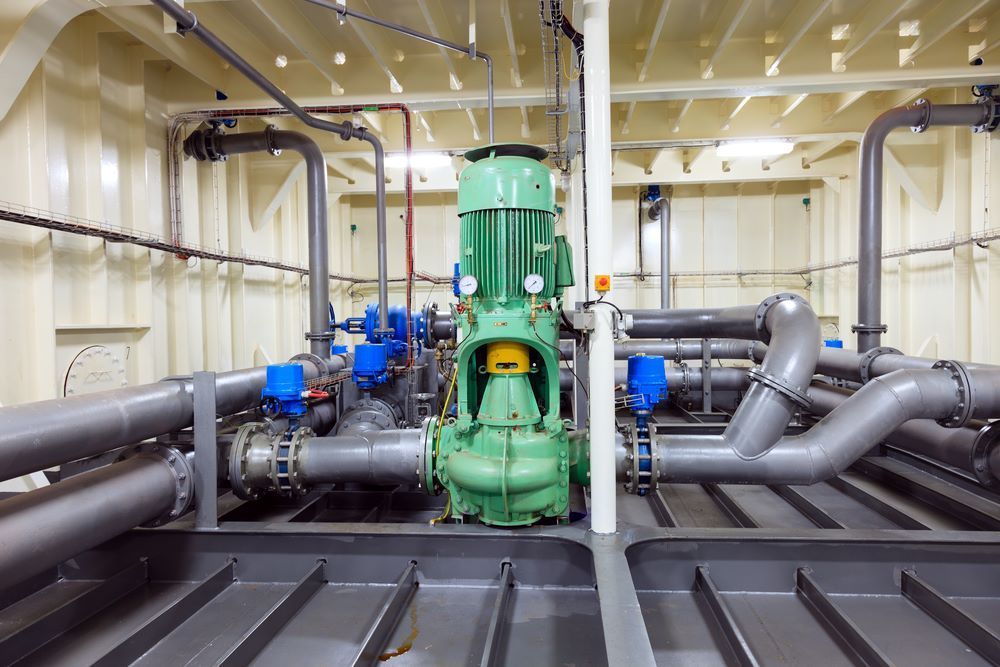A Room Filled With Pipeline And A Green Pump — Blackpoly Pipelines in Mount Isa, QLD