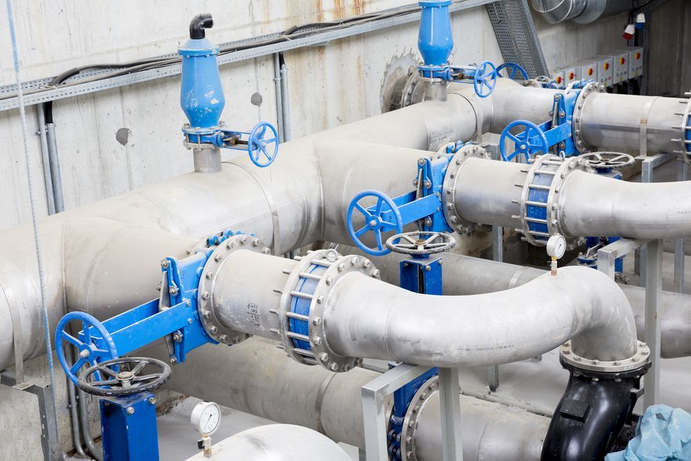 A Bunch Of Pipes With Blue Valves In A Factory — Blackpoly Pipelines in Mudgee, NSW