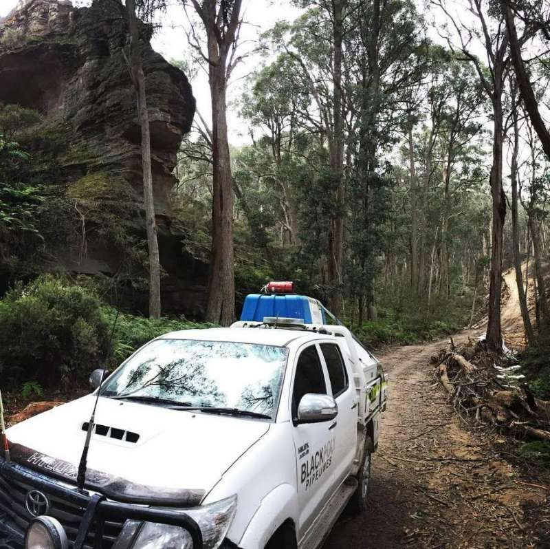 A White Truck Is Parked On A Dirt Road In The Woods — Blackpoly Pipelines in Forbes, NSW