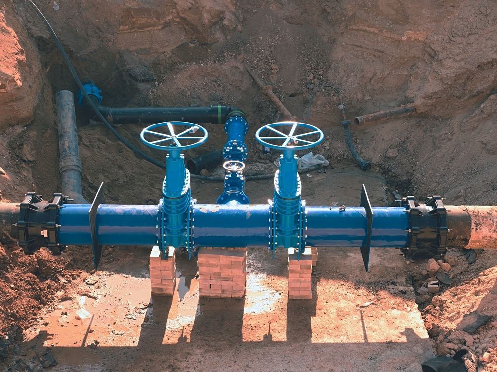 A Blue Pipe With Two Valves Attached To It — Blackpoly Pipelines in Mudgee, NSW
