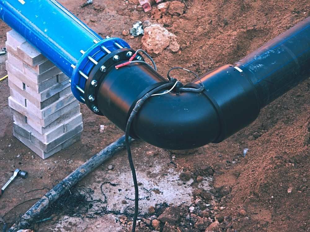 A Black Pipe With A Blue Flange Is Connected To A Blue Pipe — Blackpoly Pipelines in Young, NSW