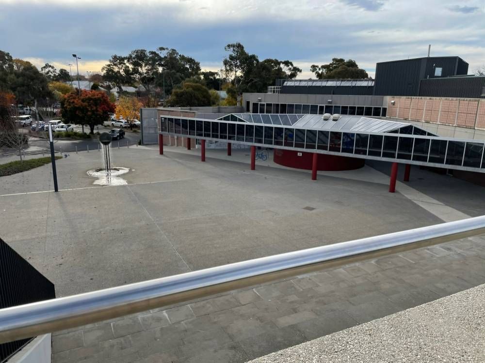 A View Of A Building From A Balcony With Trees — Blackpoly Pipelines in Orange, NSW