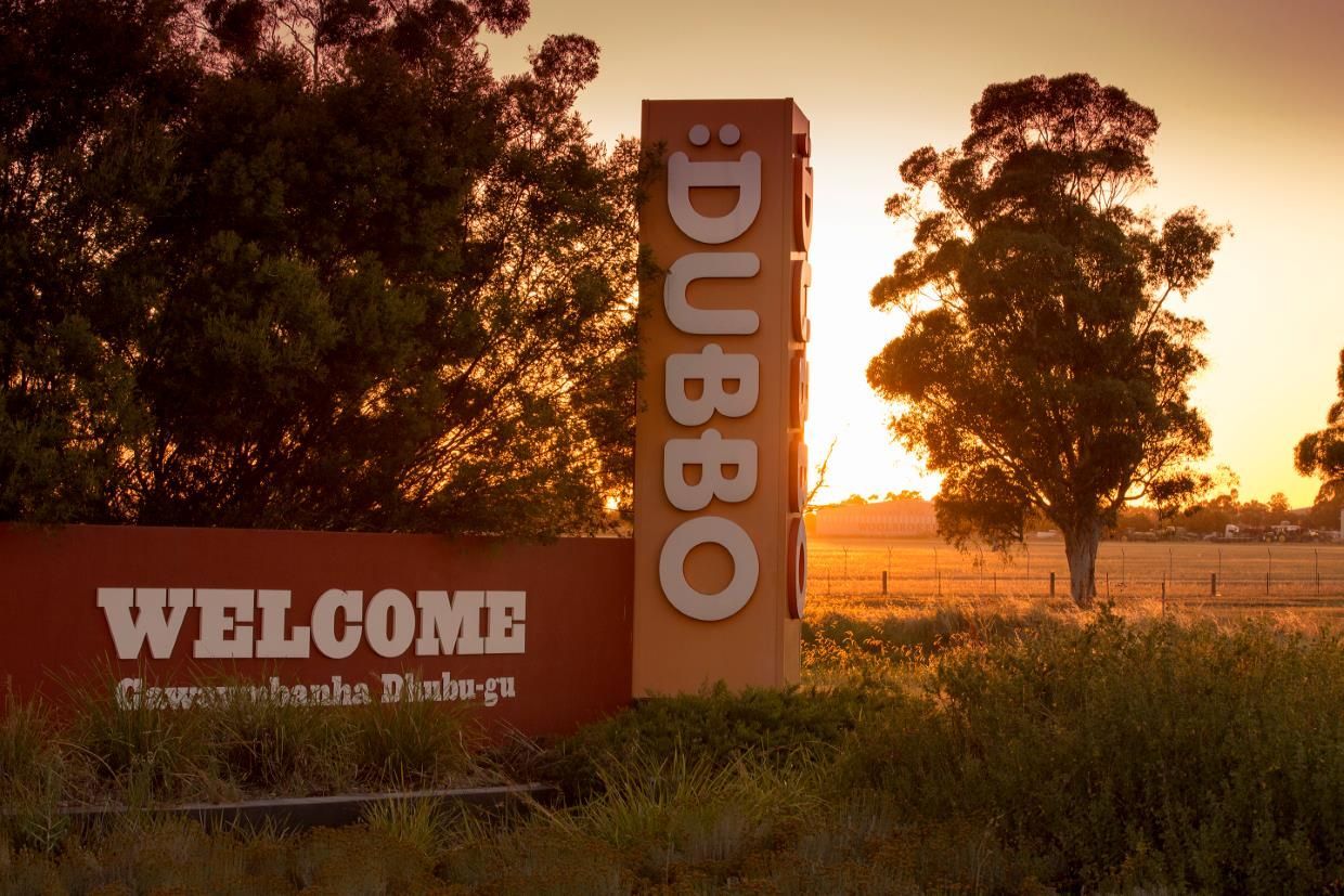 A Welcome Sign For Dubbo In A Field At Sunset — Blackpoly Pipelines in Dubbo, NSW