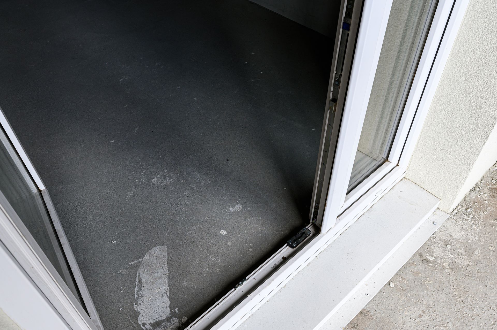 Open sliding door with a visible threshold and dark interior floor.