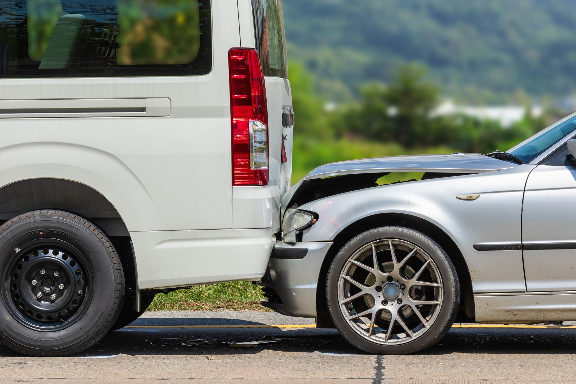 Car with a damaged front end rear-ended by a delivery van