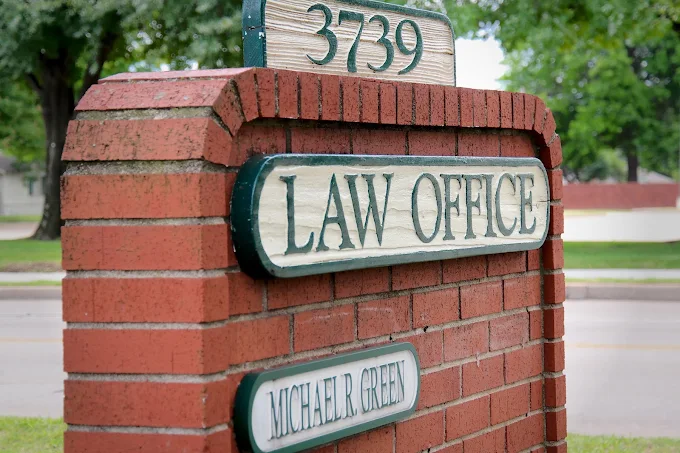 Brick law office sign with address 3739 and the name Michael R. Greeg