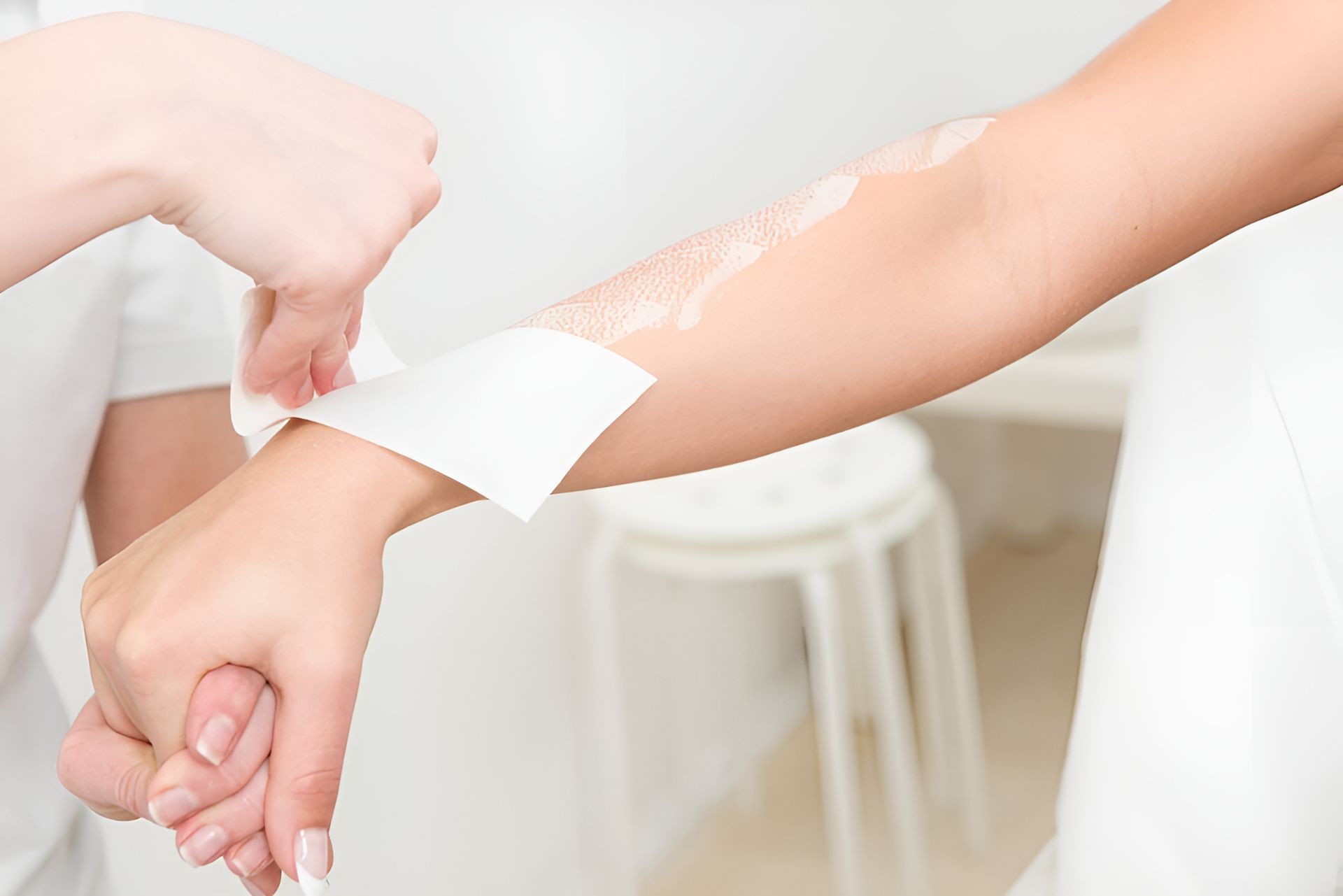 A Person Is Getting Their Arms Waxed — Skin Care Centre of Cairns In Cairns City, QLD
