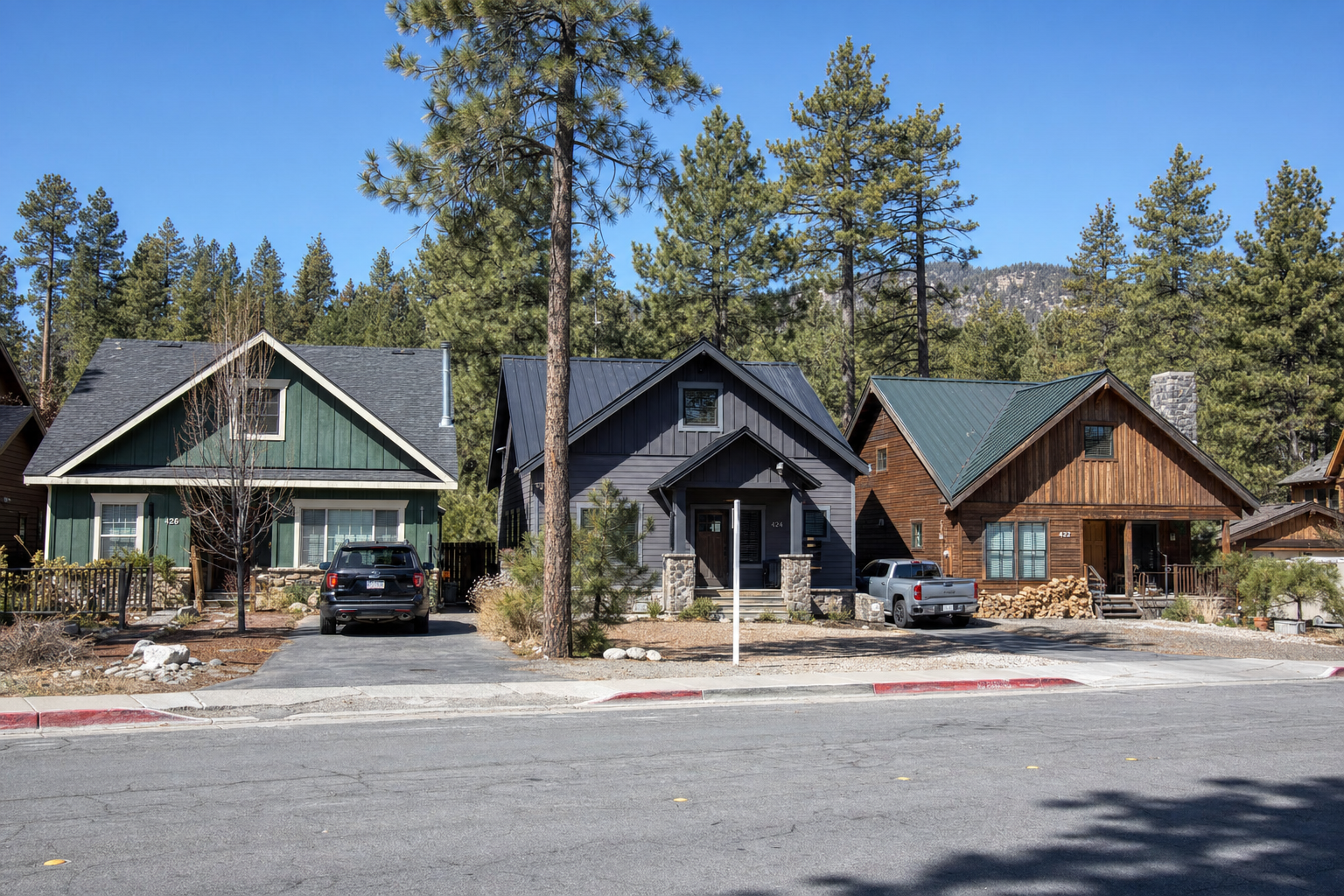 Three Big Bear cabins showing different earth-tone exterior color palettes against a pine forest 