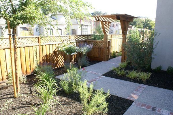 A garden with a wooden fence and a walkway | landscape design in Davis, CA