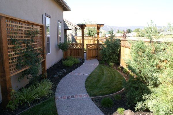A path leading to a house with a wooden fence | Paver Walkway in Davis, CA