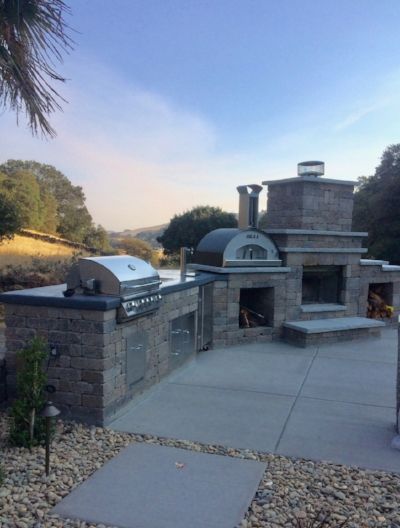 Outdoor kitchen patio with elegant pavers by Turfworks Inc., top landscaping company in Vacaville, CA.