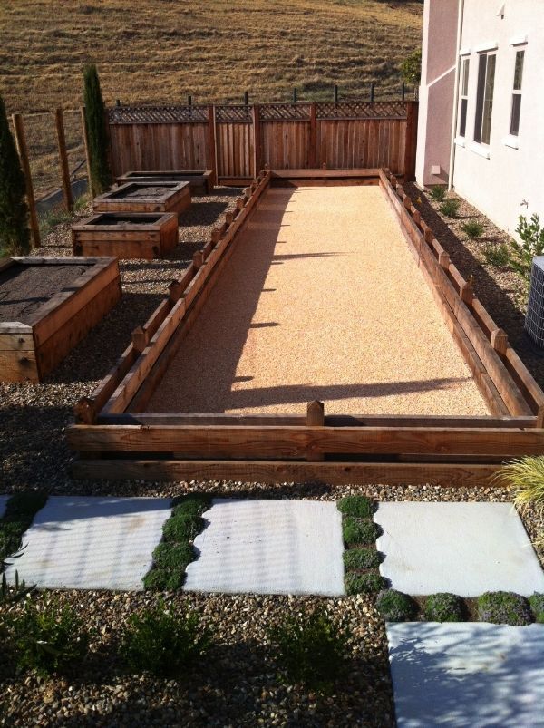 A row of wooden raised beds in a backyard designed by Turfworks, Inc., the top landscape contractor in Vacaville, CA.