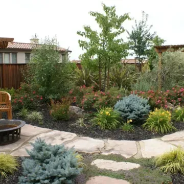 A lush green garden with a fire pit in the middle | Landscape Design in Davis, CA