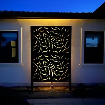 A landscape design in Davis, CA, in a white house with a black screen with leaves on it.