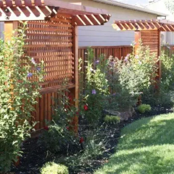 A wooden fence with a pergola in the backyard | Landscape Design in Davis, CA