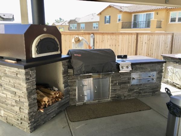Outdoor kitchen & grill with a pizza oven by Turfworks, Inc., top-rated landscape contractor in Vacaville, CA.