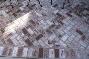 A close up of a paver walkway with chairs in the background | Landscape Design in Davis, CA